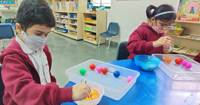 Transferring Balls Activity by LKG Students